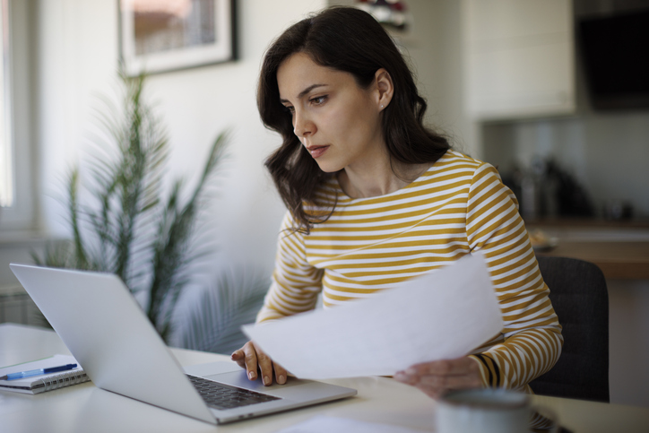 Woman working on her tax planning at home
